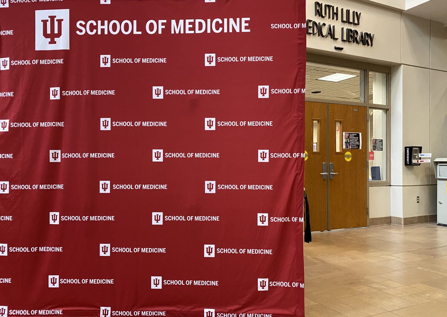 An image of IU School Of Medicine sign standing in front of Ruth Lilly Medical Library