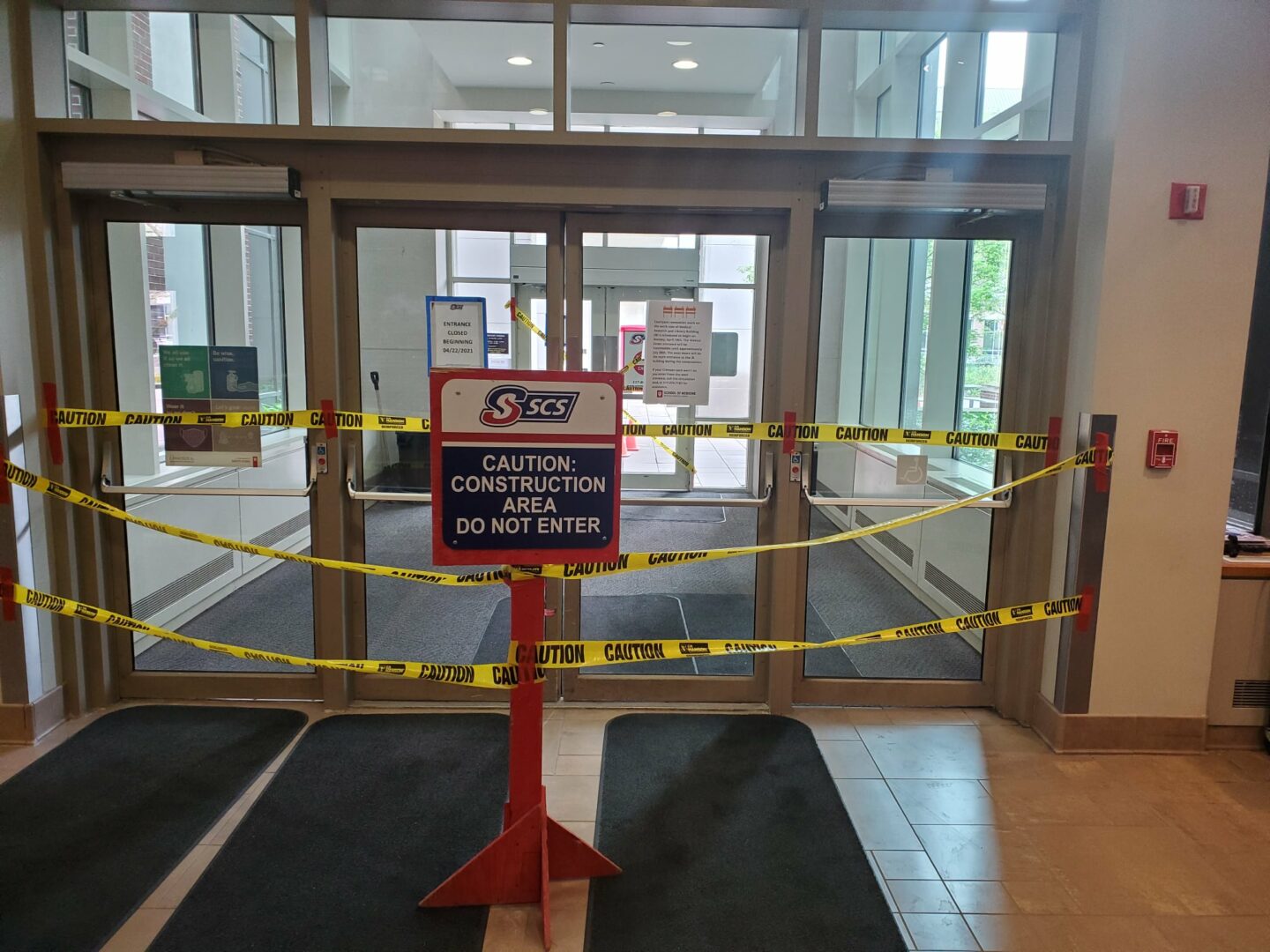 an image of caution tape around the north entrace of the library, due to renovation.